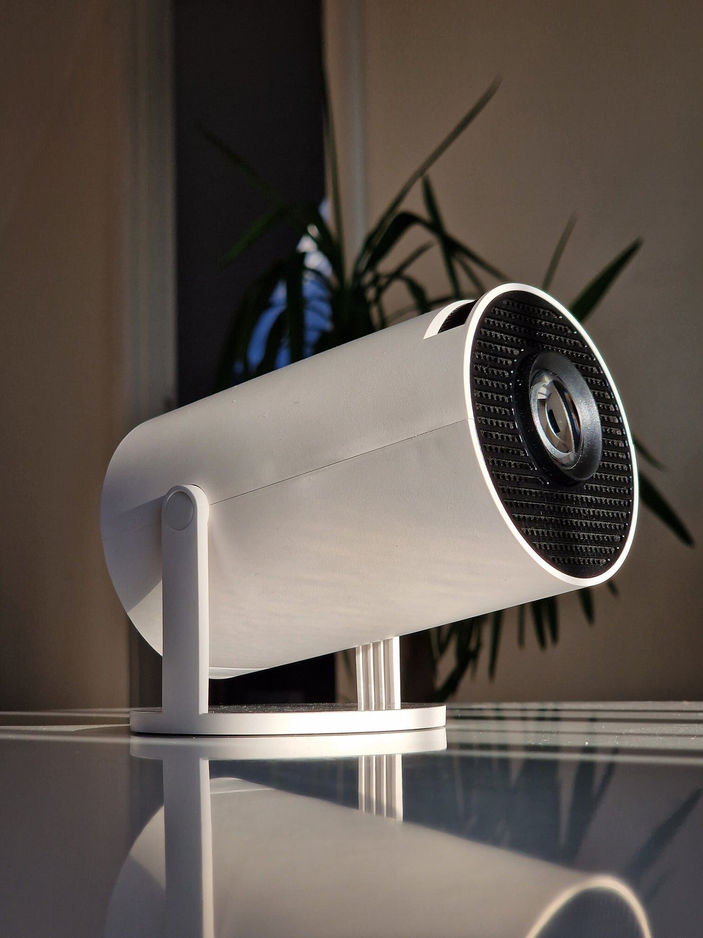 Small projector in a business presentation setting, projecting a PowerPoint slide on a smooth surface.